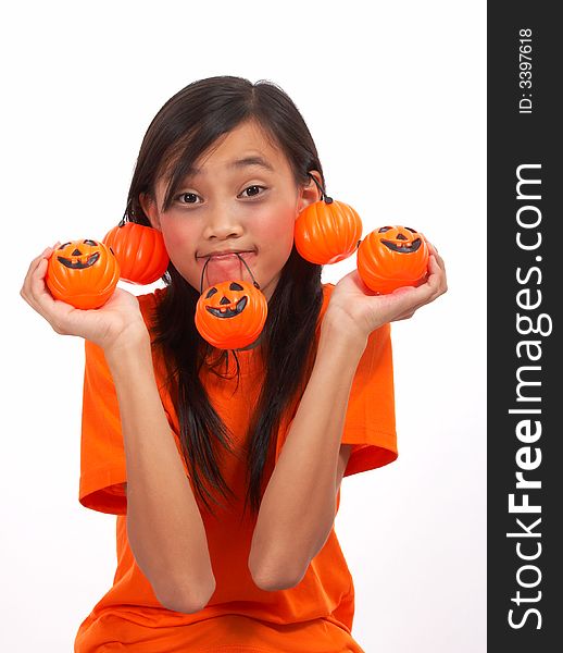 A young girl showing her pumpkins over a white background