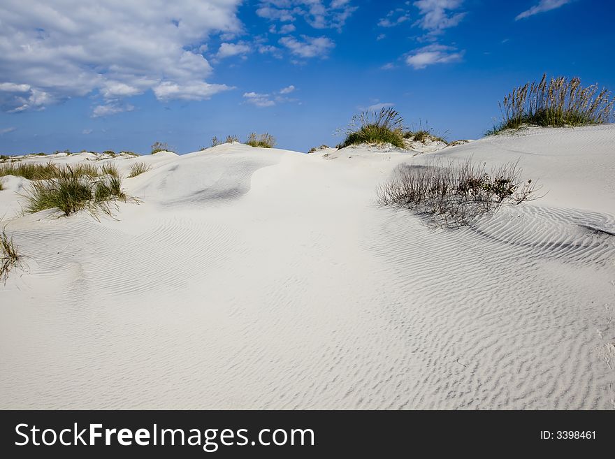 Blues sky with clouds over sandy dunes. Blues sky with clouds over sandy dunes