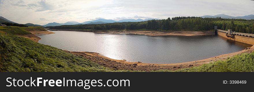 The Loch Laggan Reservoir in Scotland on a sunny day. The Loch Laggan Reservoir in Scotland on a sunny day