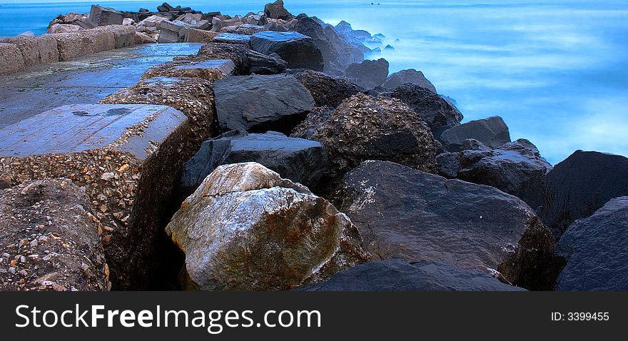 Rocks And Blue Sea At Sunset