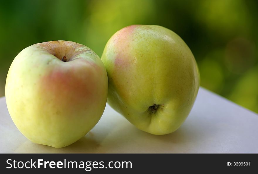 Closeup of green apples on green background.