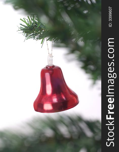 Christmas bell hanging on fir tree isolated