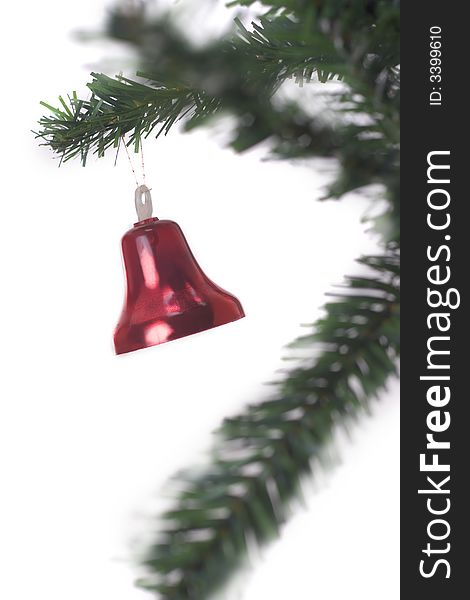 Christmas bell hanging on fir tree isolated