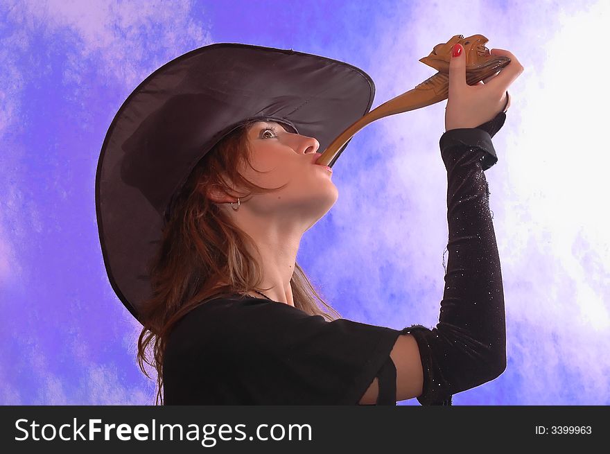 Woman dressed as the witch with pipe. Woman dressed as the witch with pipe