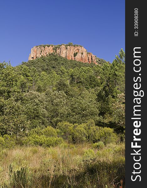 Colle Rousse, Red Rock Volcanic plug above the Blavet Gorge, Bagnols en Foret, The Var France. Colle Rousse, Red Rock Volcanic plug above the Blavet Gorge, Bagnols en Foret, The Var France