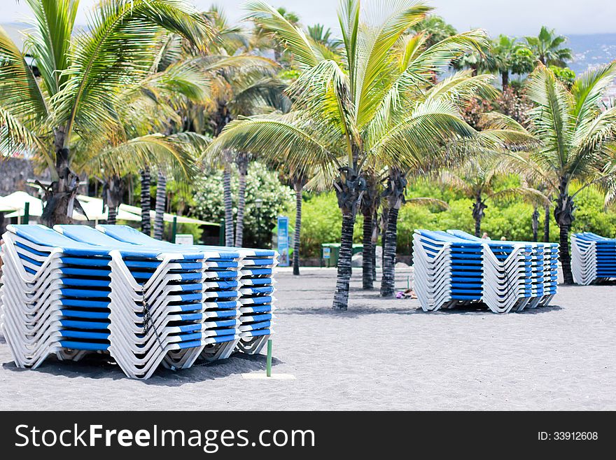 Piles of sunbeds on the beach