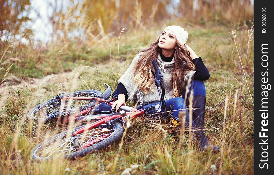 Woman Cyclist Relaxing In Autumn Park
