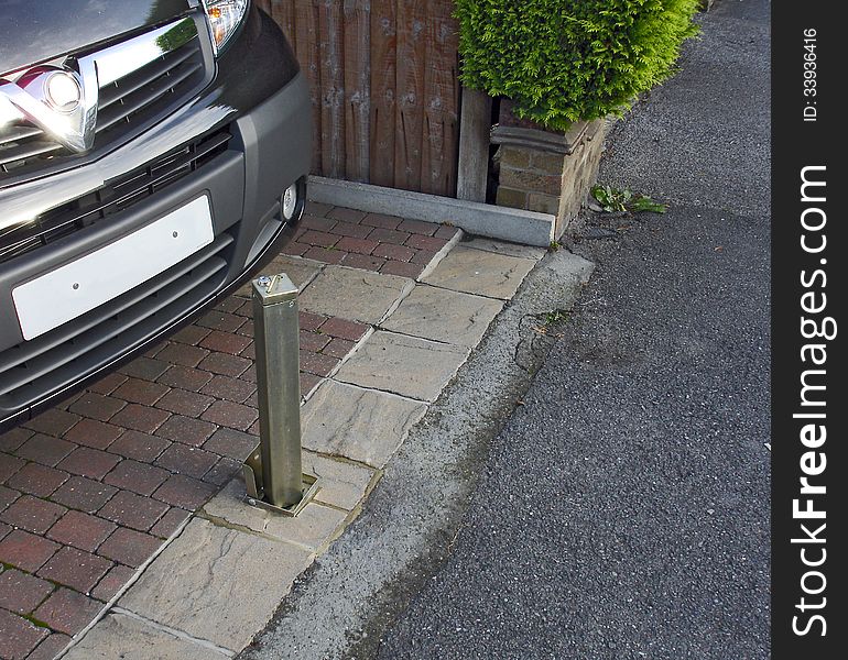 A vehicle security post in a garden in the locked up position to deter thieves.