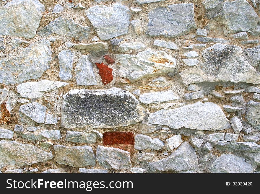 Very old wall of medieval natural stones