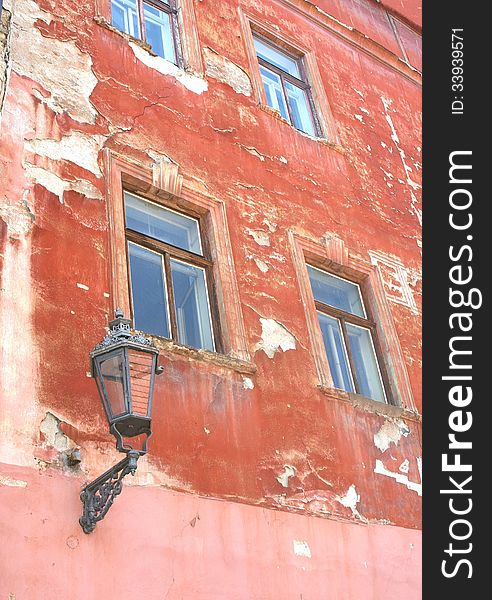 Grungy old weathered facade with old lantern, Cesky Krumlov, Czech Republic