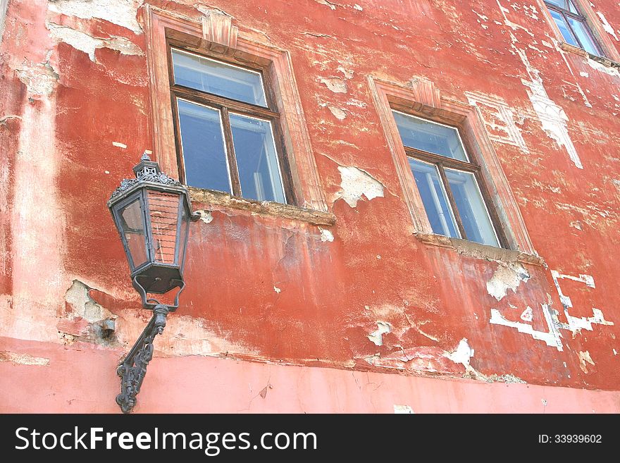 Grungy medieval facade with old lantern, Cesky Krumlov, Czech Republic