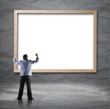 Businessman Looking For White Backdrop With Wooden Frame Stock Photo Businessman Looking For White Backdrop With Wooden Frame Stock Photo