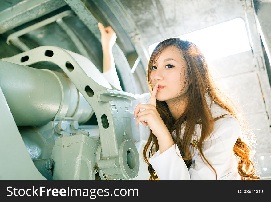 Pretty woman sailor posing silence expression on battleship