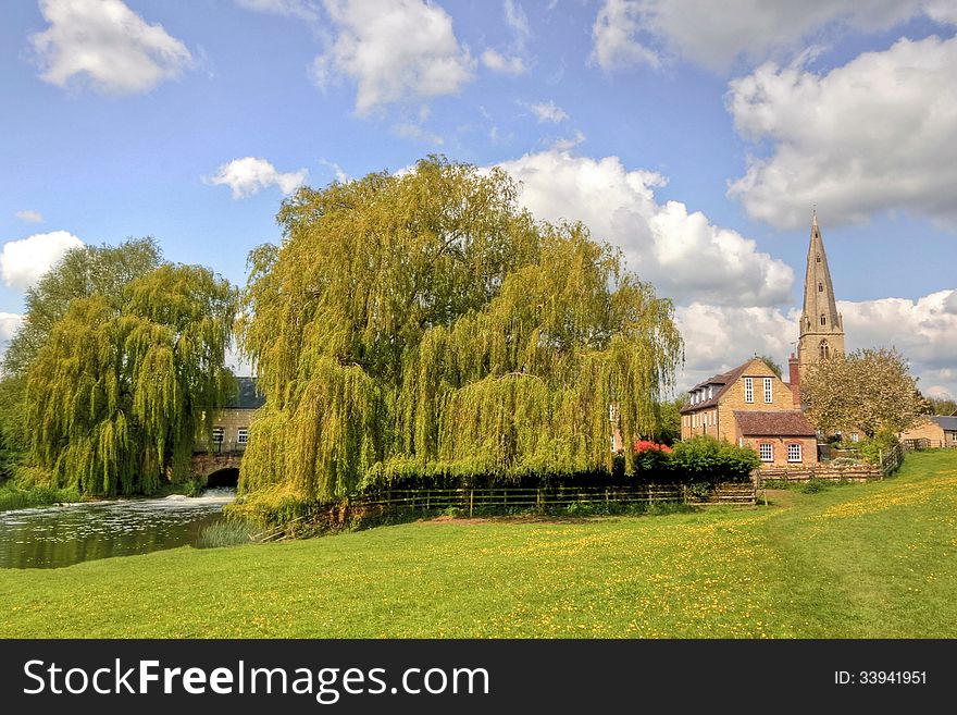 Landscape of a small market town's Church spire - mill house - mill race and willow trees. Landscape of a small market town's Church spire - mill house - mill race and willow trees