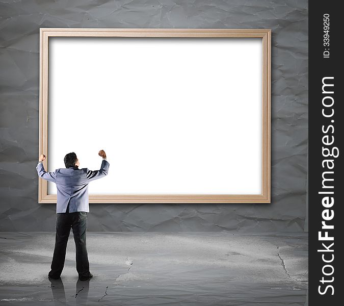 Businessman looking for white backdrop with wooden frame use for background layout design