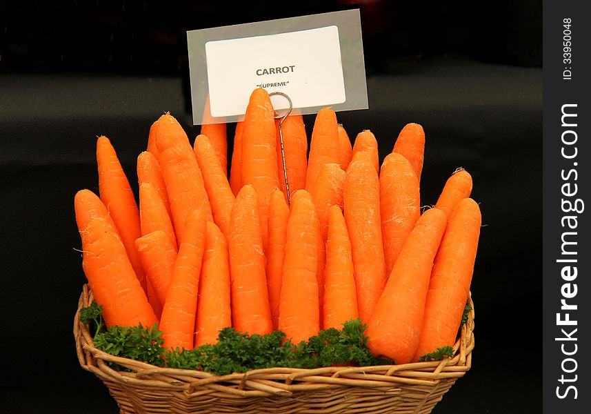 A Display of Fresh Carrots in a Wicker Basket. A Display of Fresh Carrots in a Wicker Basket.