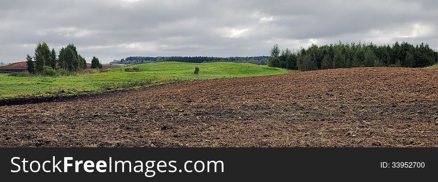 Plowed field at cloudy day