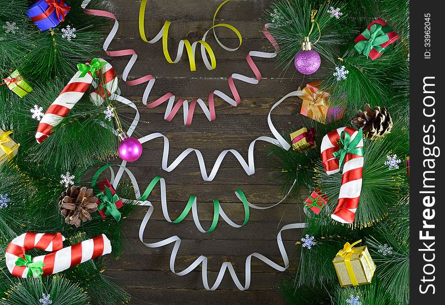 Christmas background with toys, baubles and conifer on wooden background. Christmas background with toys, baubles and conifer on wooden background