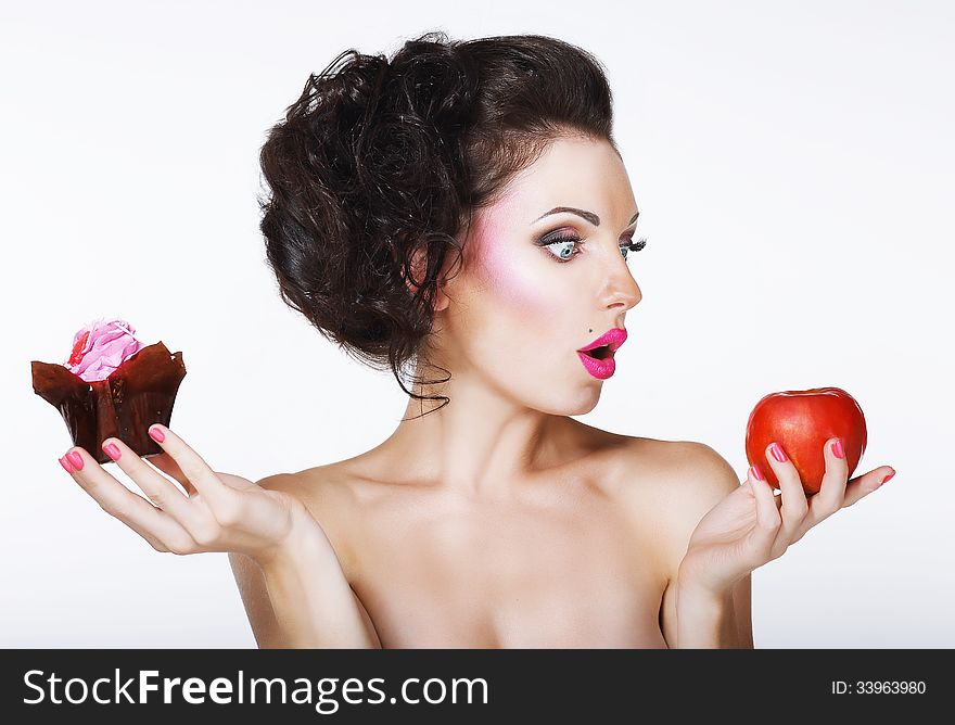 Surprised Funny Woman Decides between Apple and Cake