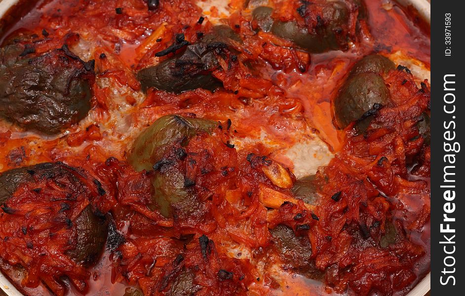 Hot stuffed pepper with vegetables in the stewpot closeup