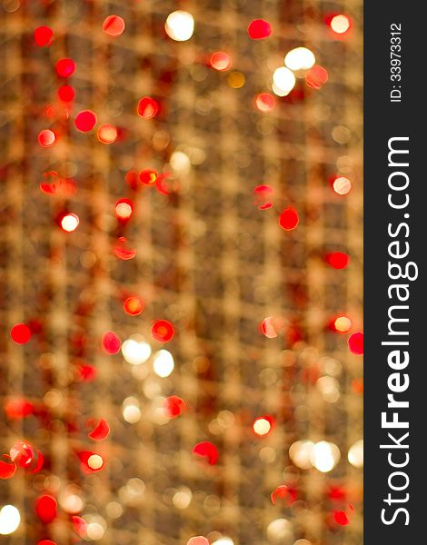 Red golden glowing background. Christmas card. Abstract background with bokeh defocused lights and stars