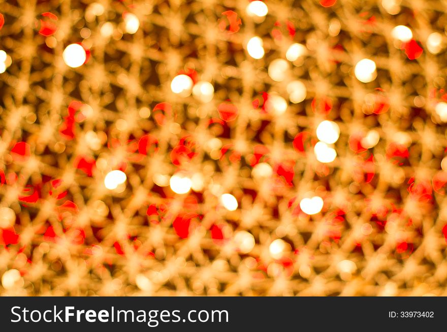 Red golden glowing background. Christmas card. Abstract background with bokeh defocused lights and stars