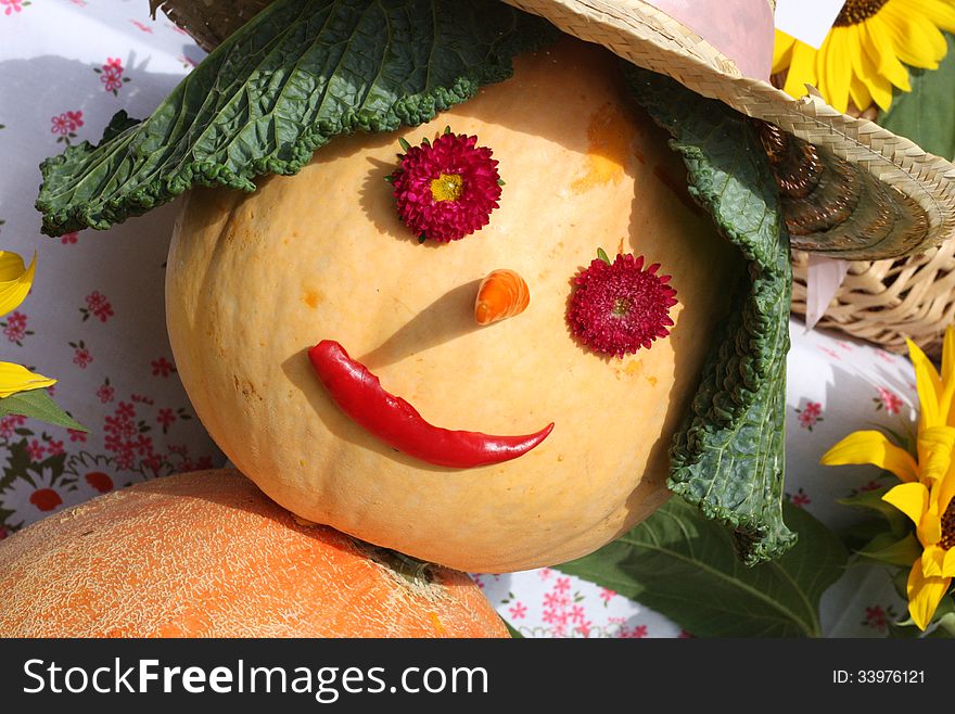 Smiling pumpkin in hat and hair with cabbage. Smiling pumpkin in hat and hair with cabbage