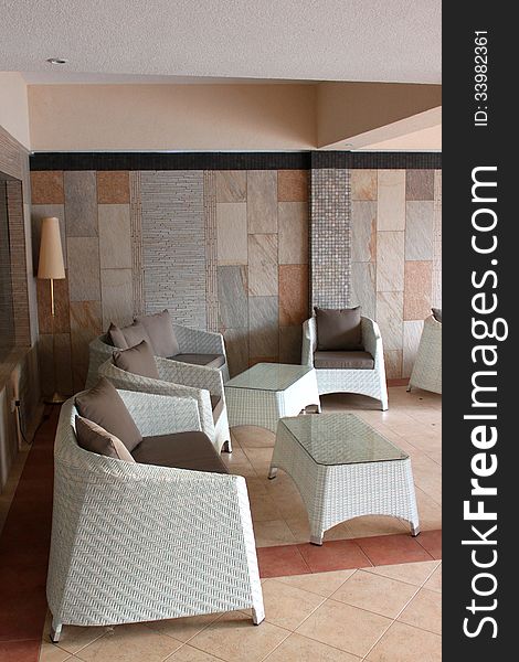 A hotel lobby with rattan white furniture