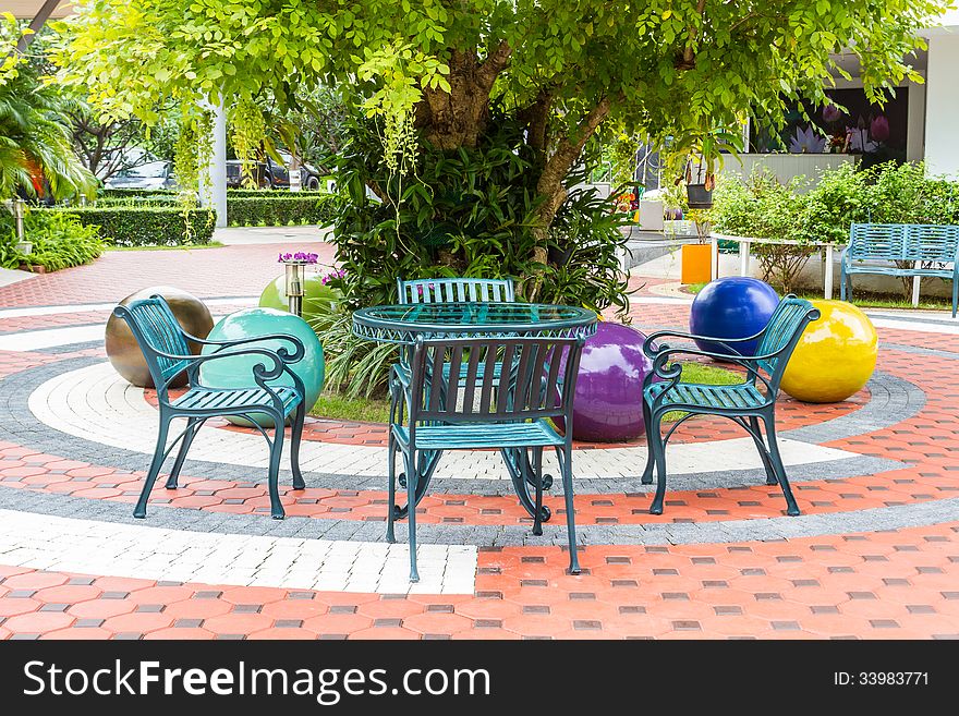 Outdoor chair in the garden under the tree.