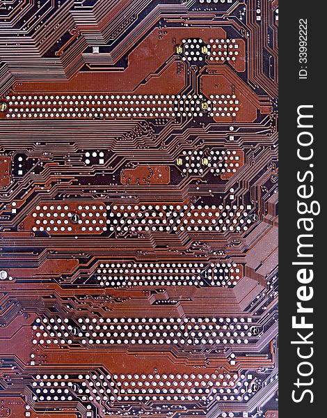 A close up shot of a computer brown motherboard. A close up shot of a computer brown motherboard.