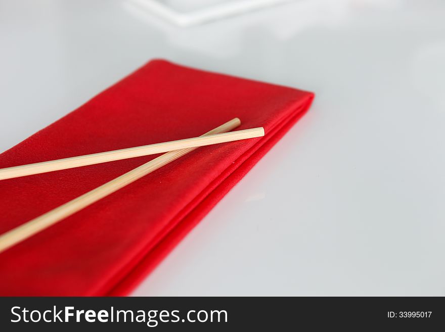 Japanese Sushi sticks on the red napkin.