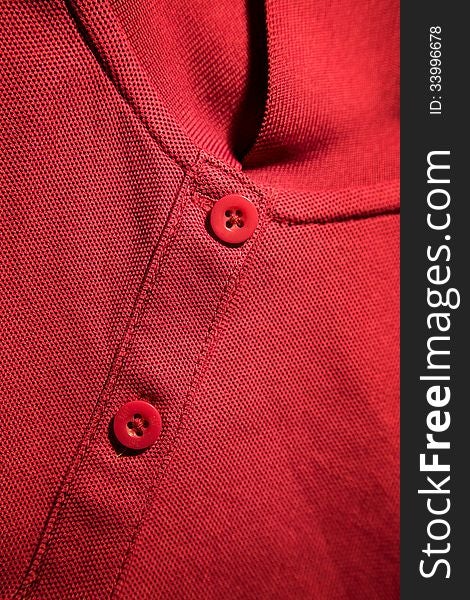 Red t-shirt details:neckline and buttons. Red t-shirt details:neckline and buttons