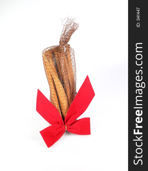 Cinnamon sticks and red bow over white. Cinnamon sticks and red bow over white