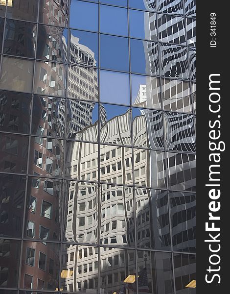 Buildings reflected in the glass face of a building. Buildings reflected in the glass face of a building.