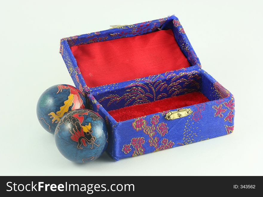 An open asian box with stressballs next to it. An open asian box with stressballs next to it.