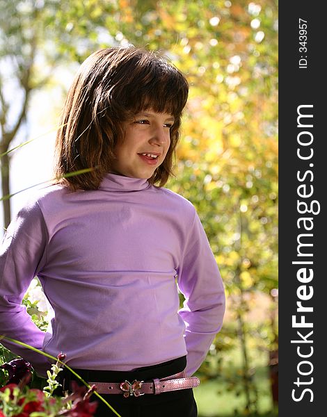 An adorable young Hispanic American girl in the 5-8 year old range. She is wearing a pink purple turtleneck shirt, butterfly belt and has a wonderful smile. An adorable young Hispanic American girl in the 5-8 year old range. She is wearing a pink purple turtleneck shirt, butterfly belt and has a wonderful smile.