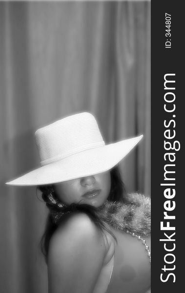 Black & white glamour image of a teen with a hat. Black & white glamour image of a teen with a hat