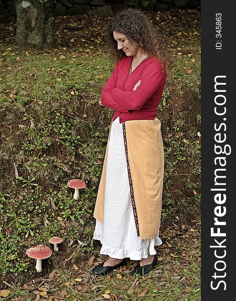 Mushroom lady watching fly agaric poisonous mushrooms in field