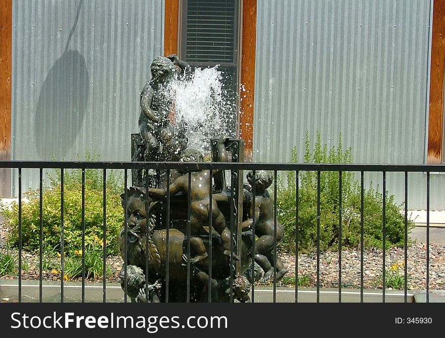 Water fountain outside with corigated metal background