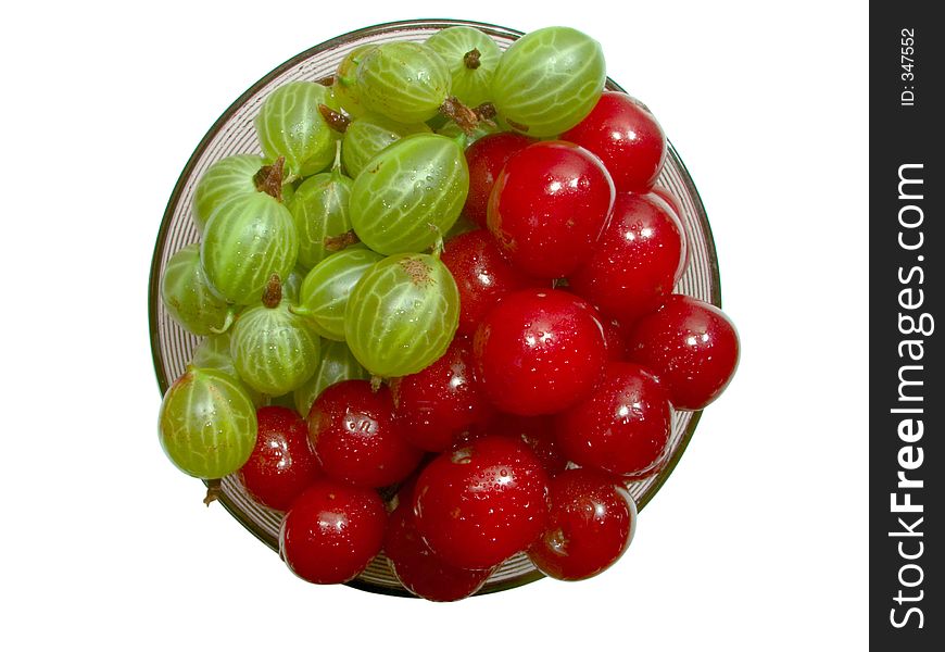 Top view of cherries and gooseberries in the glass jam dish. Top view of cherries and gooseberries in the glass jam dish