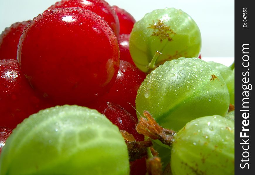 Fresh cherries and gooseberries with drops on them. Fresh cherries and gooseberries with drops on them