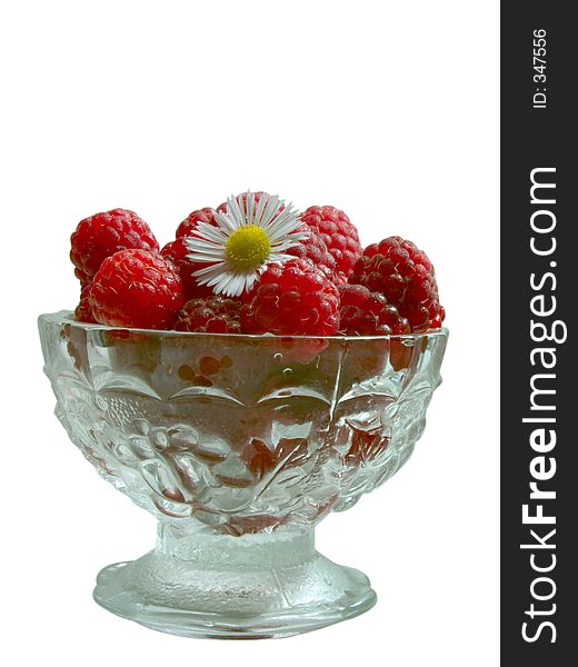 Front view of raspberries in the glass jam dish with camomile. Front view of raspberries in the glass jam dish with camomile