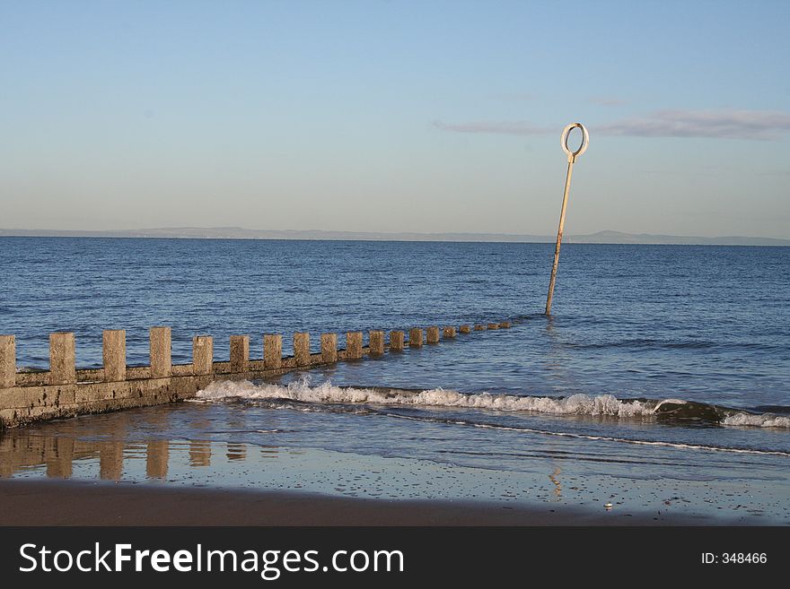 A calming image looking at sea wall out to sea.