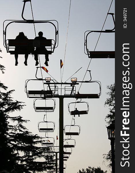 Silhouette of people on the ski lift ride at the county fair. Silhouette of people on the ski lift ride at the county fair