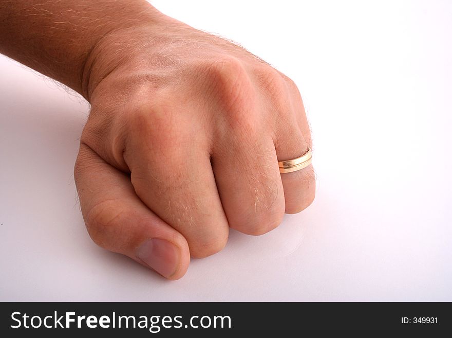 Isolated man's fist with wedding band. Isolated man's fist with wedding band