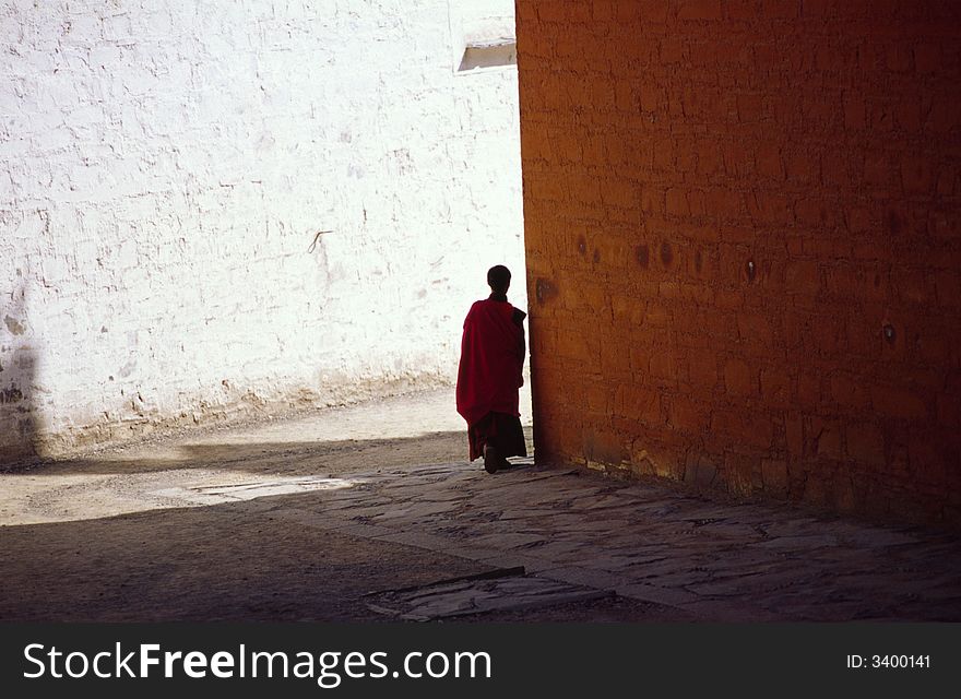 A lama silhouette on the wall of LaPuLen lamasery,Gansu province,China. A lama silhouette on the wall of LaPuLen lamasery,Gansu province,China