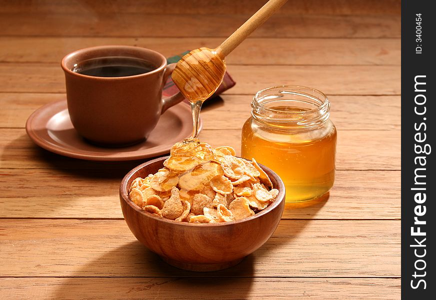 Breakfast scene. Honey pouring into a cereal bowl. Breakfast scene. Honey pouring into a cereal bowl