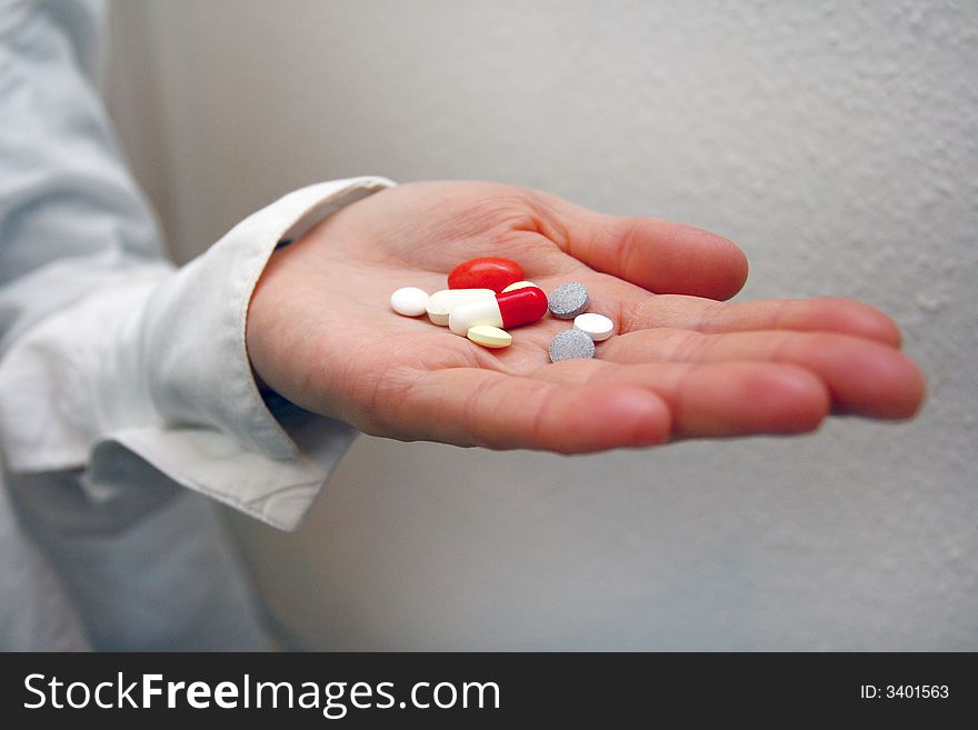 Pills are in the hands of doctor