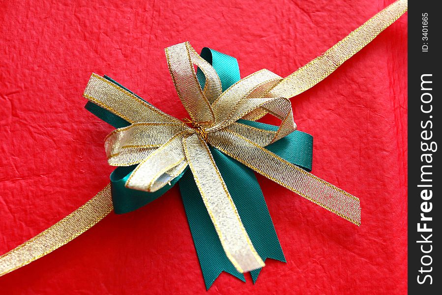 Christmas decoration bow from a green and gold ribbon