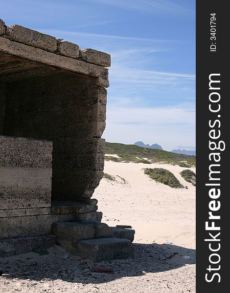 Ruins on a beach against a blue sky